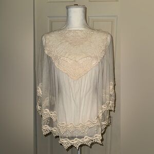 White lace/sheer poncho w lace on bellflower sleeves. Similar to Chloé AW/24